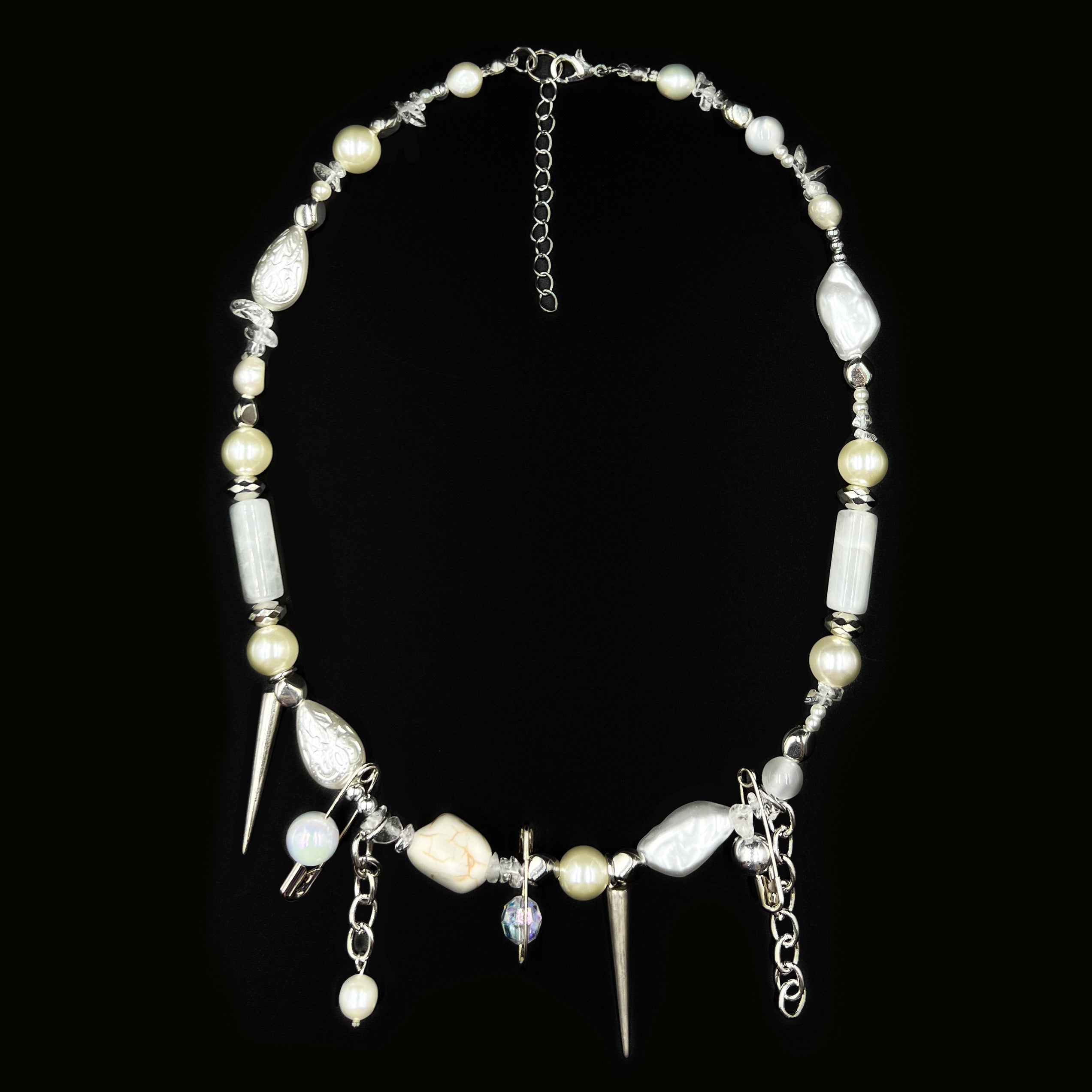 Pearl and silver necklace on black velvet